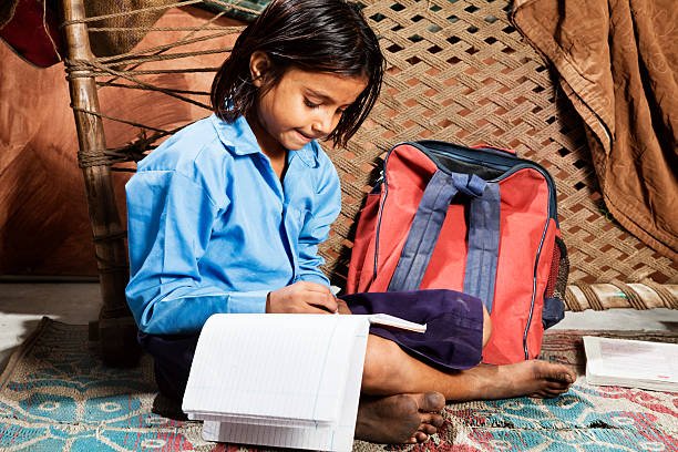 indian schoolgirl doing her homework  at home